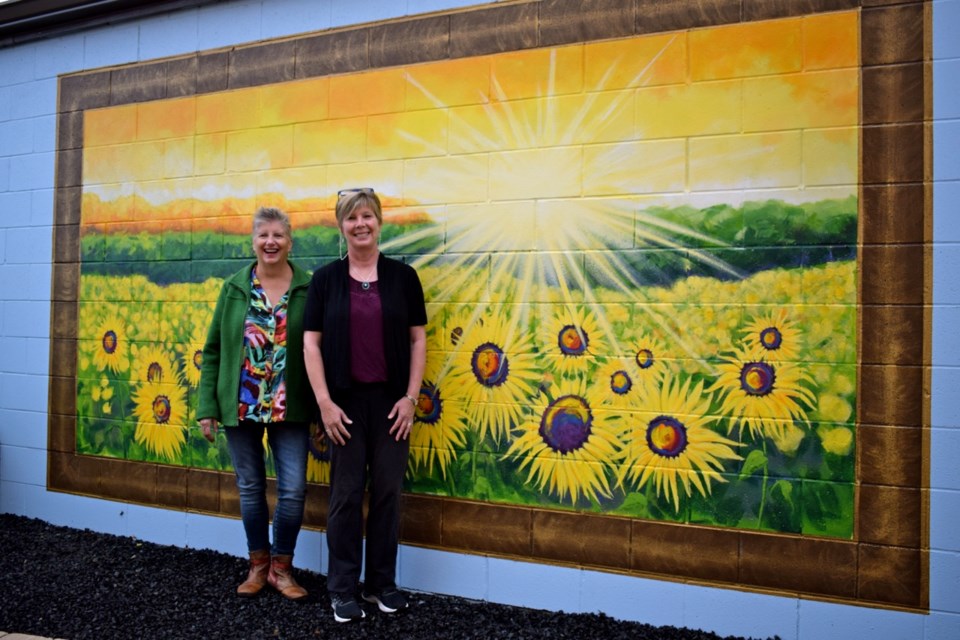 renda Blackburn and Gale Tytlandsvik teamed up to create the sunrise over the field of the sunflowers mural. 