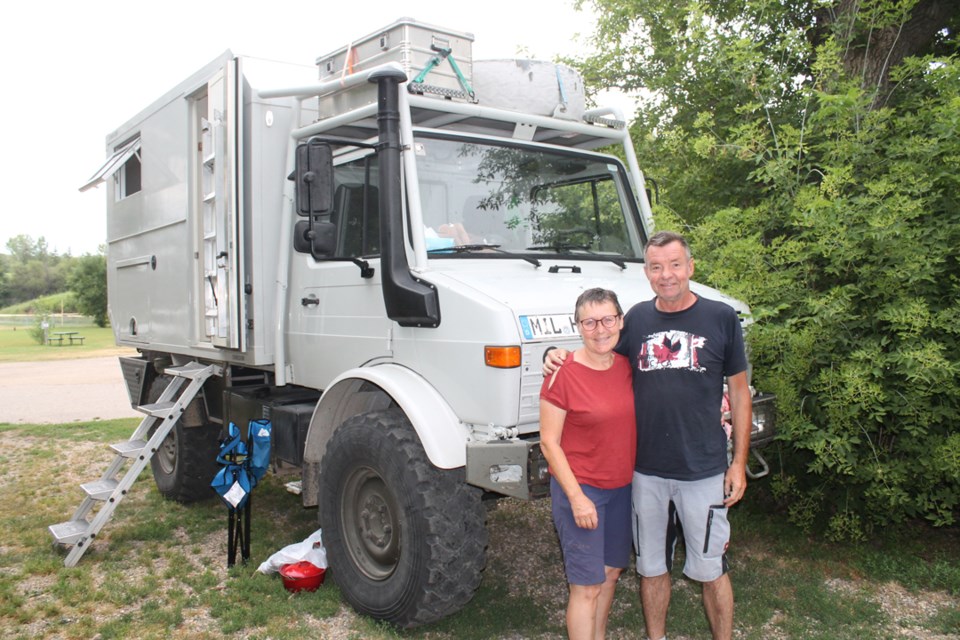 Norbert and Heidi Stahlroth standing in front of their very unique home. 
