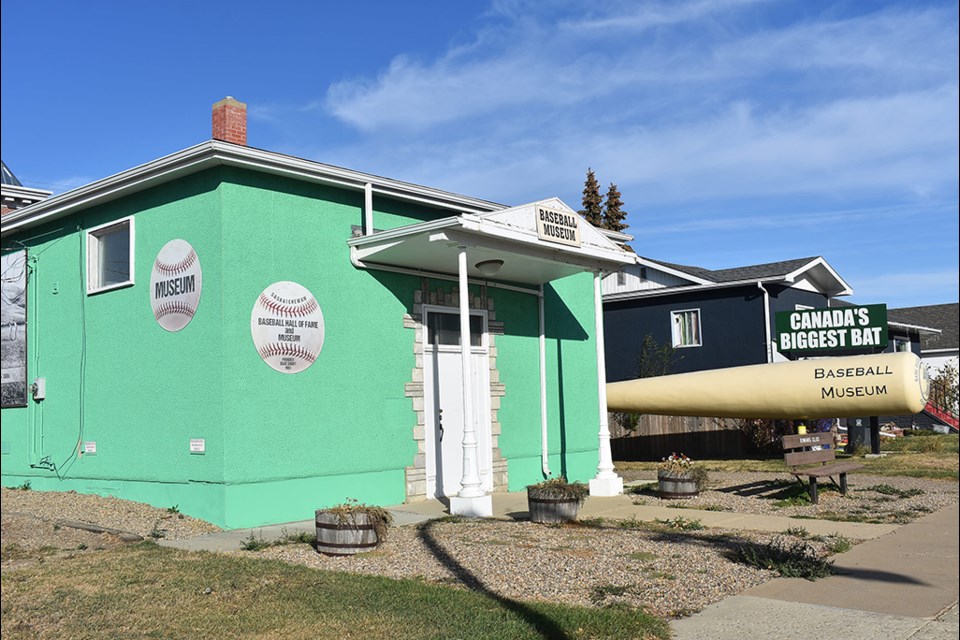 The Saskatchewan Museum &  Baseball Hall of Fame pictured with the biggest baseball bat in Canada.