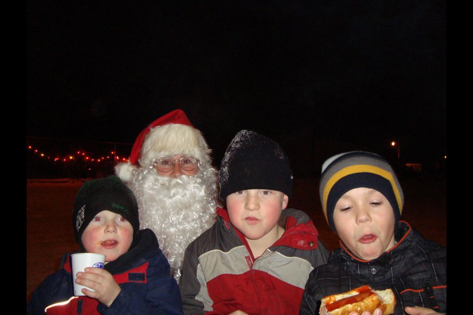 Three young boys got to tell Santa their wish lists while sipping hot chocolate and eating hot dogs at the 2010 Night of Lights put on by the Unity Credit Union, which was the beginning of the annual Winter Wonderland.
