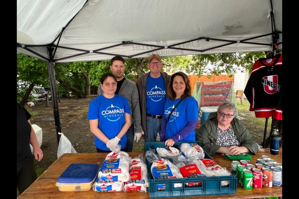 Compass Minerals sponsored and helped serve at the Unity Miners fundraising barbecue, part of a rainy Saturday at Unity Western Days.