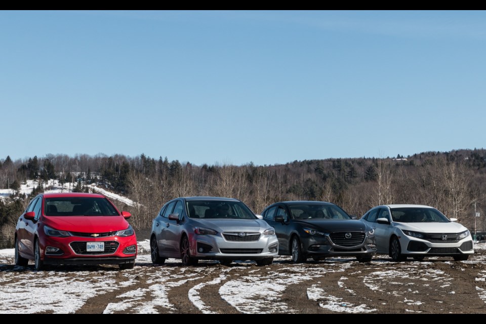 The compact hatchback confrontation: Cruze, Impreza, Mazda3 and Civic. Credit Marc-André Gauthier