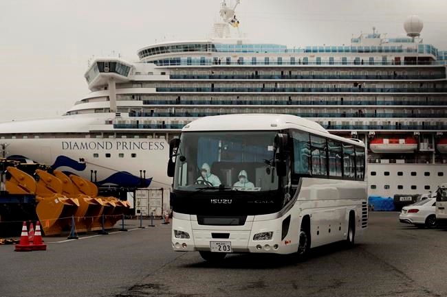 A bus leaves a port where the quarantined Diamond Princess cruise ship is docked Saturday, Feb. 15, 2020, in Yokohama, near Tokyo. The federal government says it will evacuate Canadians quarantined aboard a cruise ship docked in Japan. (THE CANADIAN PRESS/AP-Jae C. Hong)