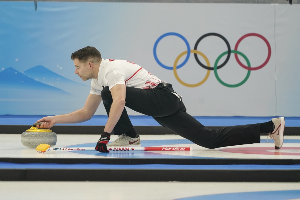 John Morris, of Canada, during the mixed doubles curling match at the Beijing Winter Olympics in Beijing. (AP Photo/Brynn Anderson)