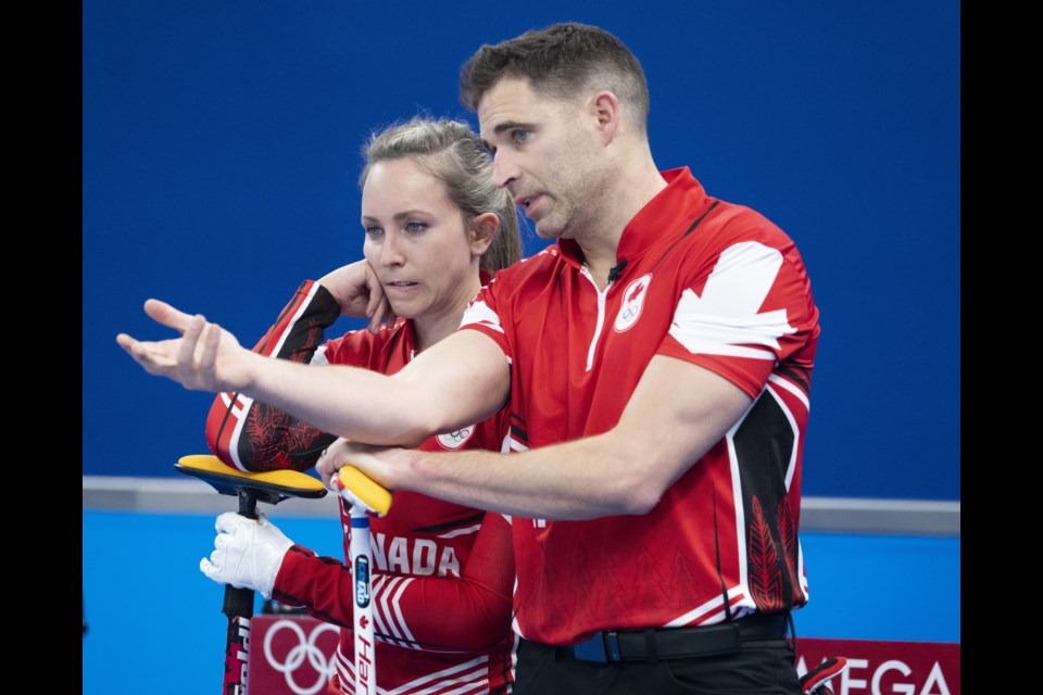Canada’s Rachel Homan and John Morris discuss a shot during preliminary round mixed curling against Czech Republic Sunday (Feb. 6) at the 2022 Winter Olympics in Beijing. THE CANADIAN PRESS/Ryan Remiorz