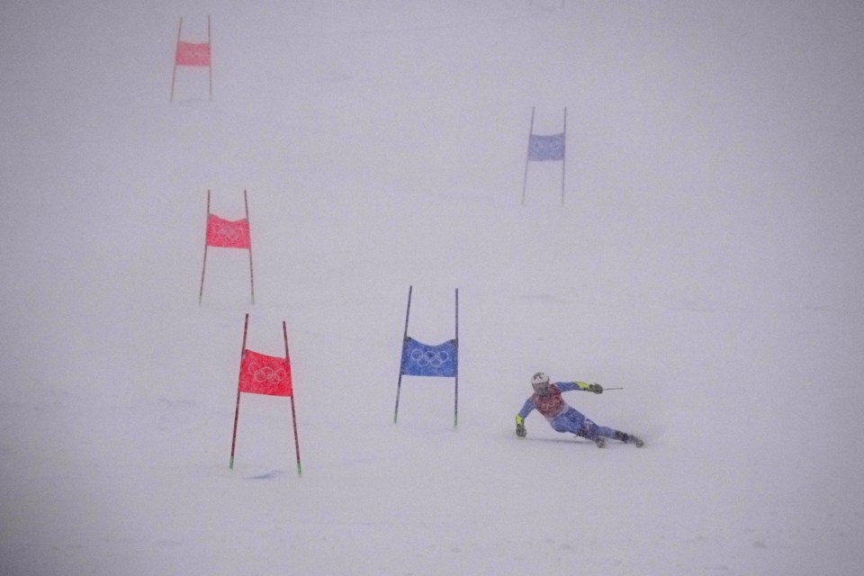 Luca De Aliprandini, of Italy passes a gate during the first run of the men's giant slalom at the 2022 Winter Olympics, Sunday, Feb. 13, 2022, in the Yanqing district of Beijing. (AP Photo/Robert F. Bukaty)