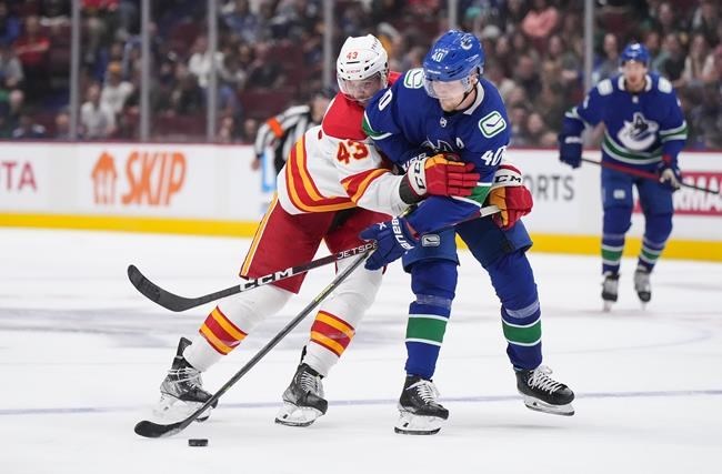 Stone scores in OT as Flames take 3-2 overtime win over Canucks