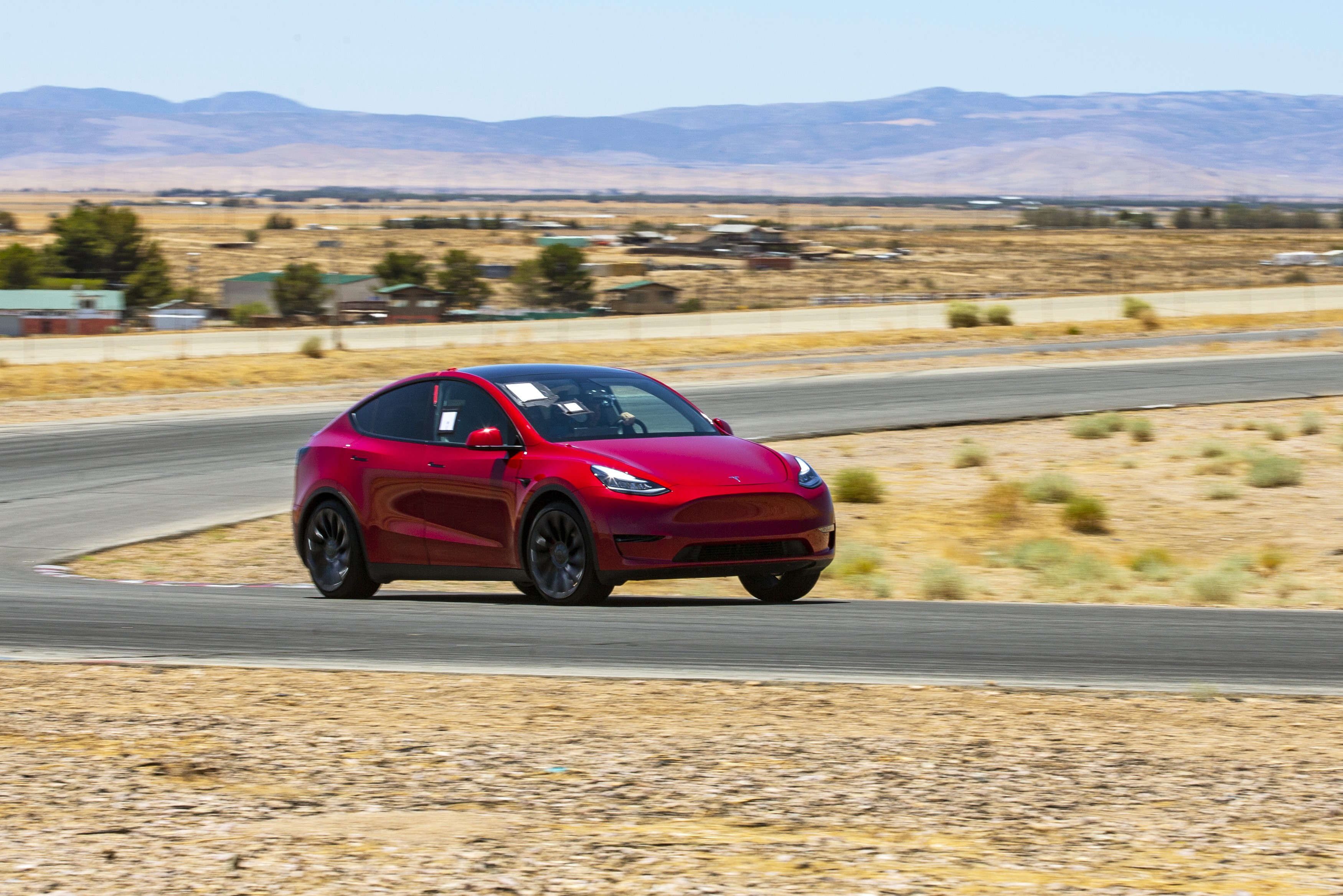 Futuristic Tesla Model Y SUV on Rocky Shore