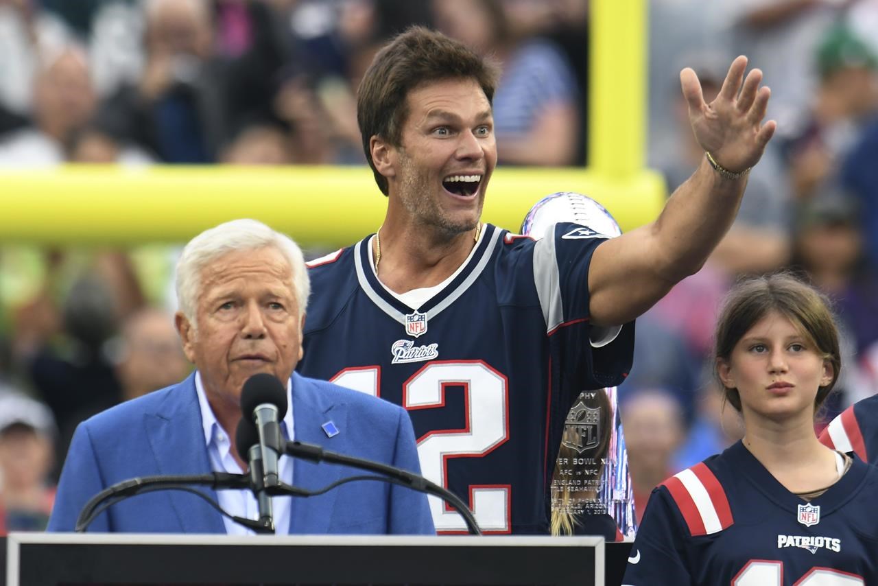 New England Patriots quarterback Tom Brady, right, celebrates a