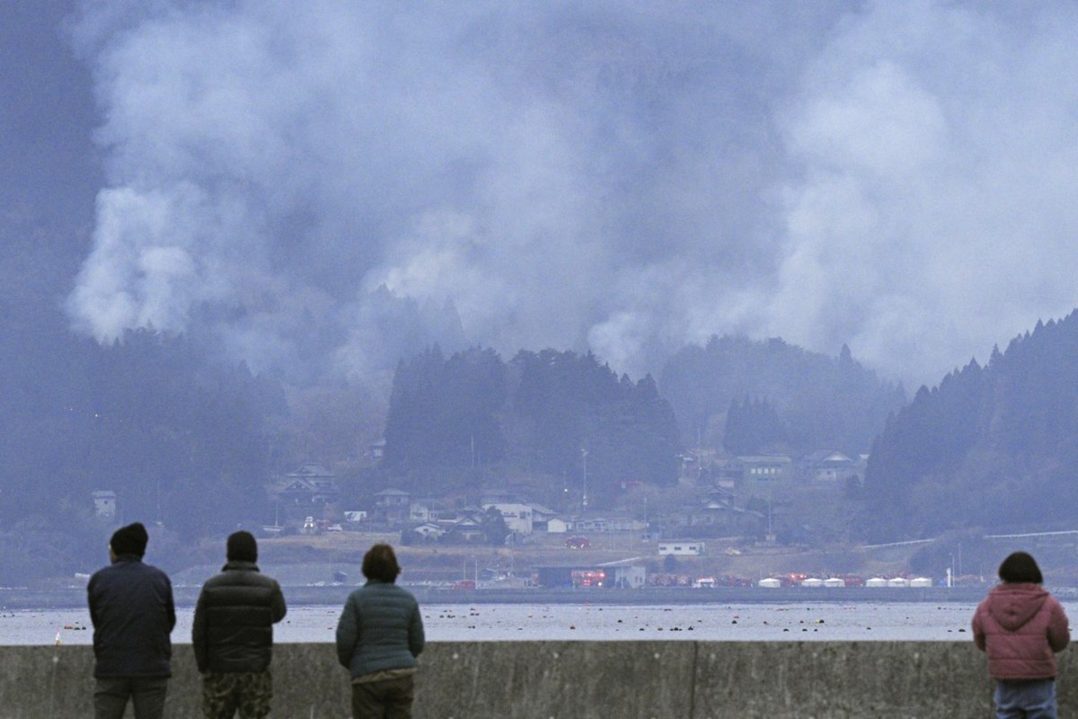 Japan fights a forest fire that has damaged dozens of homes and caused