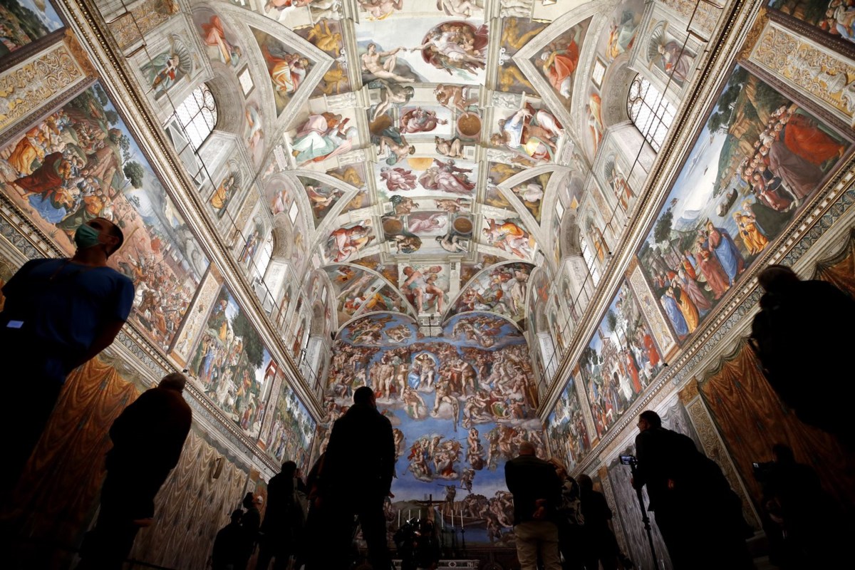 Vatican firefighters install a chimney on the roof of the Sistine Chapel for the papal election