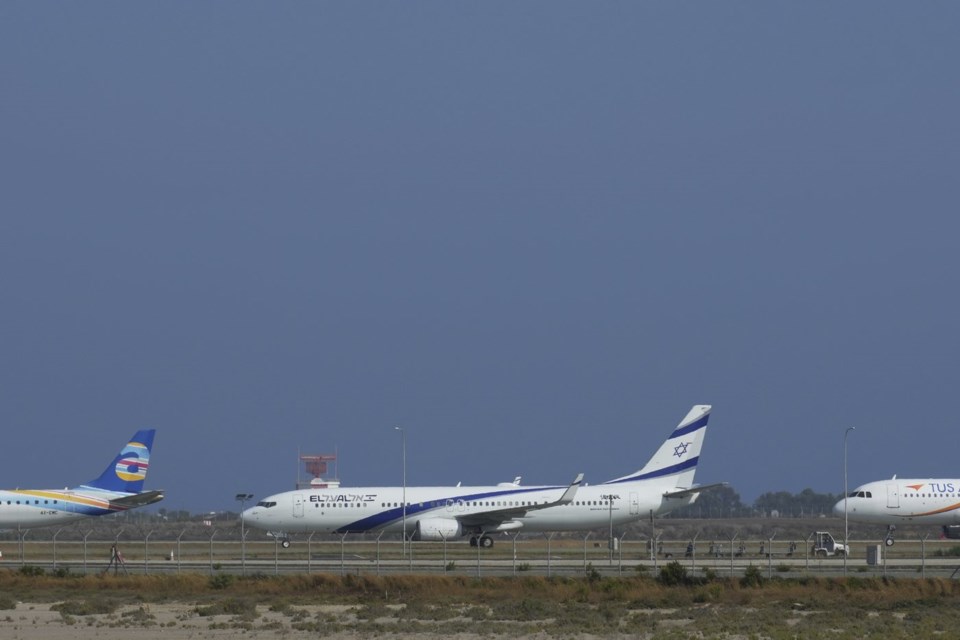 An aircraft belonging to Israeli airlines El Al sit parked in the tarmac of Cyprus' main airport in Larnaca, Saturday, June 14, 2025. (AP Photo/Petros Karadjias)
