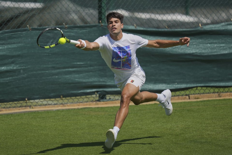 Carlos Alcaraz of Spain plays a return during a practice session ahead of the Wimbledon Championships in London, Friday, June 27, 2025. (AP Photo/Kin Cheung)