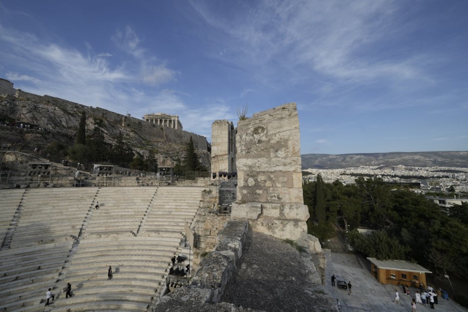 Ushers prepare the Odeon of Herodes Atticus ahead of the dress rehearsal of Giacomo Puccini's 