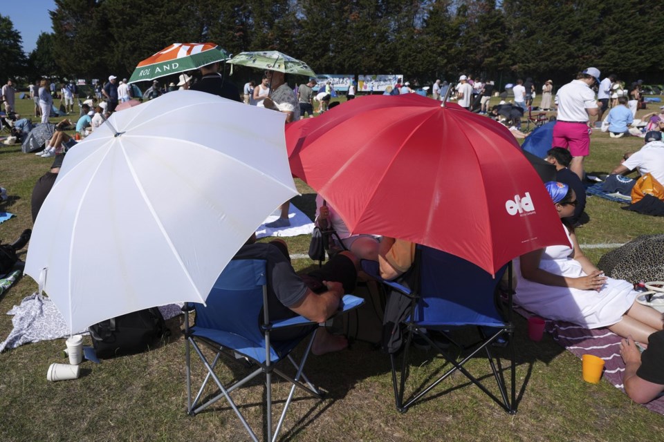 People queue at the entrance on the first day of the Wimbledon Tennis Championships in London, Monday, June 30, 2025. (AP Photo/Alastair Grant)