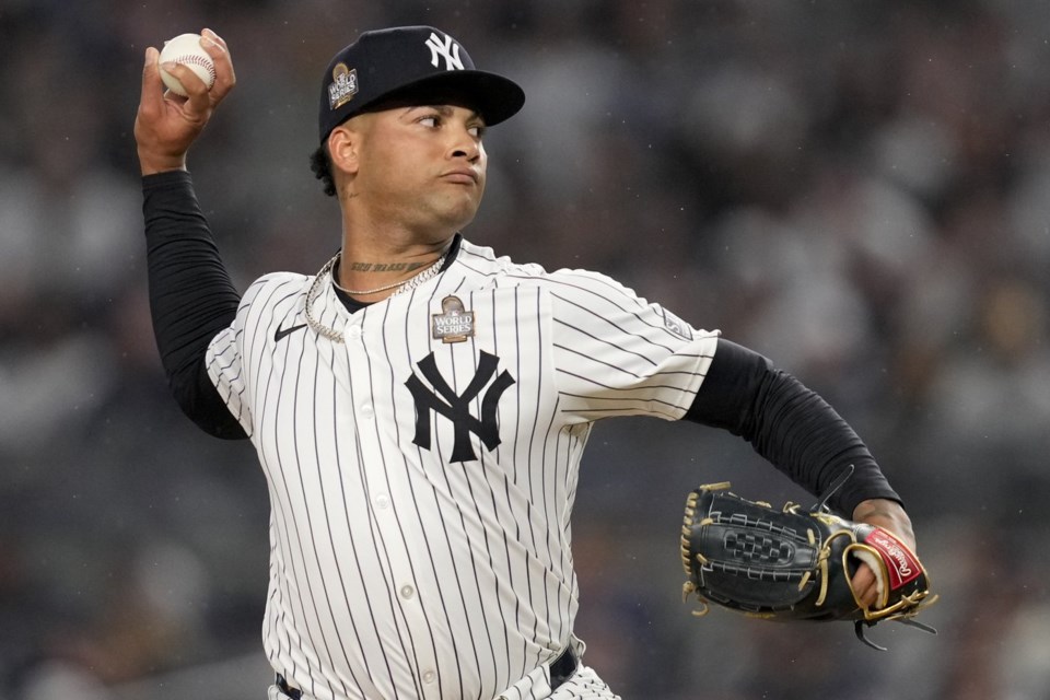 FILE - New York Yankees pitcher Luis Gil throws against the Los Angeles Dodgers during the first inning in Game 4 of the baseball World Series, Tuesday, Oct. 29, 2024, in New York. (AP Photo/Ashley Landis, File)