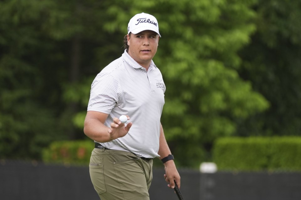 Aldrich Potgieter, of South Africa, waves after his putt on the ninth hole during the first round of the Rocket Classic golf tournament at the Detroit Golf Club, Thursday, June 26, 2025, in Detroit. (AP Photo/Paul Sancya)