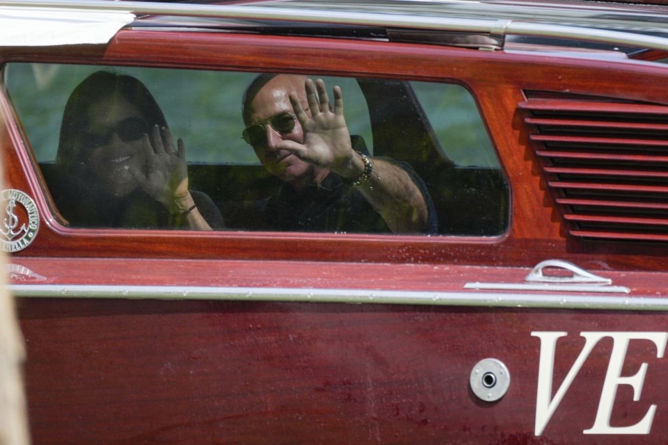 Amazon multi-billionaire founder Jeff Bezos, right, and Lauren Sanchez arrive by boat at an hotel in Venice, Italy, on Wednesday, June 25, 2025, ahead of festivities in the lagoon city reportedly linked to their wedding. (AP Photo/Luca Bruno))