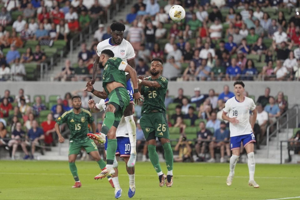 United States' Patrick Agyemang (24) leaps between Saudi Arabia's Abdulelah Alamri (4) and Ali Majrashi (26) and heads the ball towards the goal during a CONCACAF Gold Cup soccer match, Thursday, June 19, 2025, in Austin, Texas. (AP Photo/Eric Gay)
