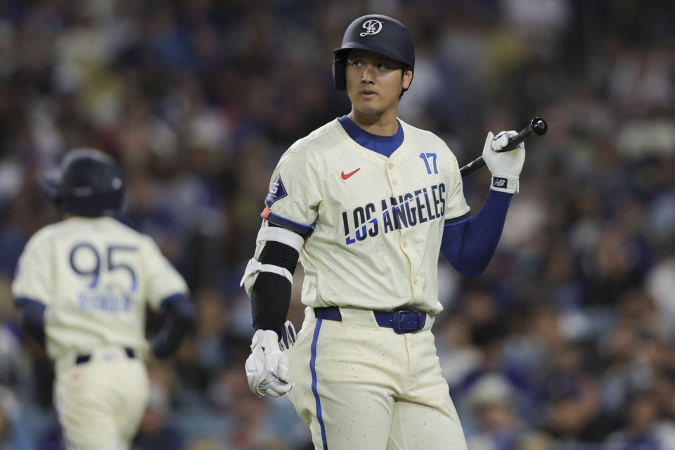 Los Angeles Dodgers designated hitter Shohei Ohtani looks on while walking to the dugout after striking out during the fifth inning of a baseball game against the Washington Nationals in Los Angeles, Saturday, June 21, 2025. (AP Photo/Jessie Alcheh)