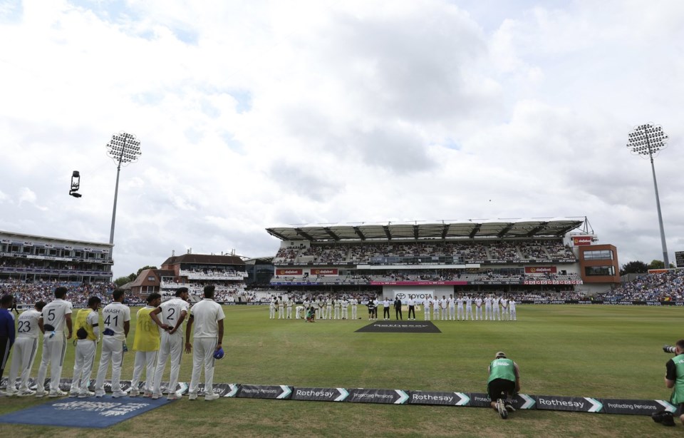 A general view of the the players from India and England as the mark a minute's applause for the passing of Dave Syd Lawrence ahead of day three of the first cricket test match between England and India at Headingley in Leeds, England, Sunday, June. 22, 2025. (AP Photo/Scott Heppell)