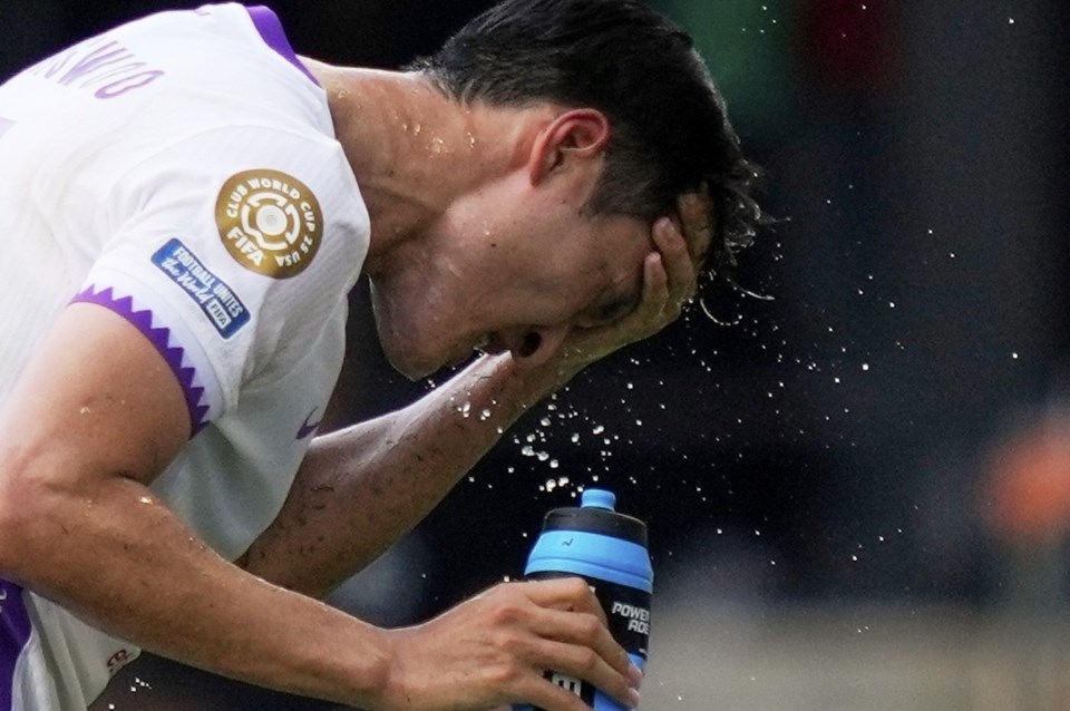 Al Ain's Park Yong-woo splashes his face to cool off during the Club World Cup Group G soccer match between Wydad AC and Al Ain FC in Washington, Thursday, June 26, 2025. (AP Photo/Julia Demaree Nikhinson)