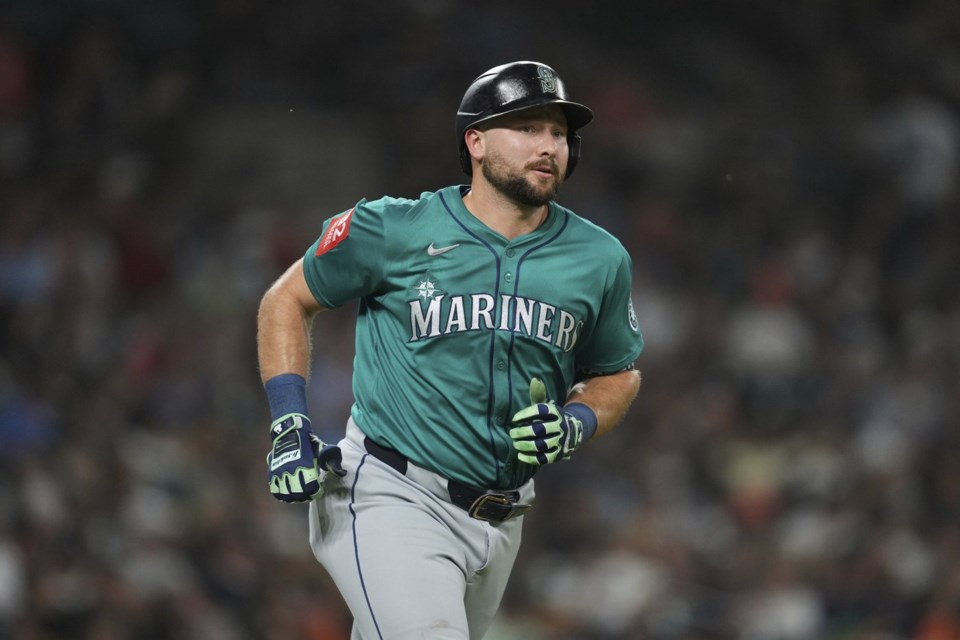 Seattle Mariners' Cal Raleigh rounds first base after hitting a grand slam against the Detroit Tigers in the ninth inning during a baseball game, Friday, July 11, 2025, in Detroit. (AP Photo/Paul Sancya)