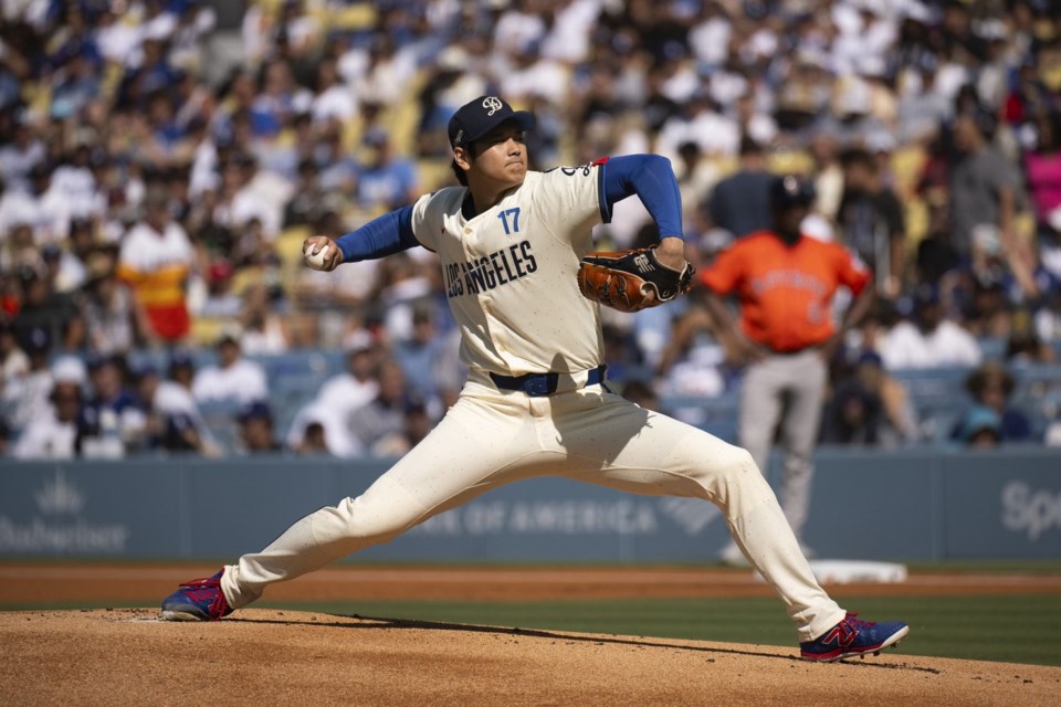 Los Angeles Dodgers starting pitcher Shohei Ohtani delivers during the first inning of a baseball game against the Houston Astros in Los Angeles, Saturday, July 5, 2025. (AP Photo/Kyusung Gong)