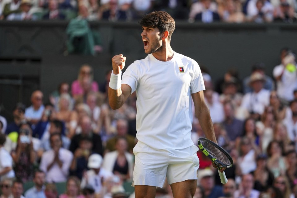 Spain's Carlos Alcaraz celebrates after beating Britain's Cameron Norrie during a quarterfinal men's singles match at the Wimbledon Tennis Championships in London, Tuesday, July 8, 2025. (AP Photo/Kirsty Wigglesworth)