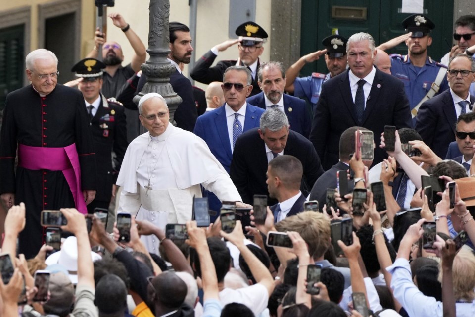 Pope Leo XIV waves to faithful as he arrives to celebrate a mass inside the St. Thomas of Villanova church in Castel Gandolfo, Sunday, July 13, 2025. (AP Photo/Gregorio Borgia)
