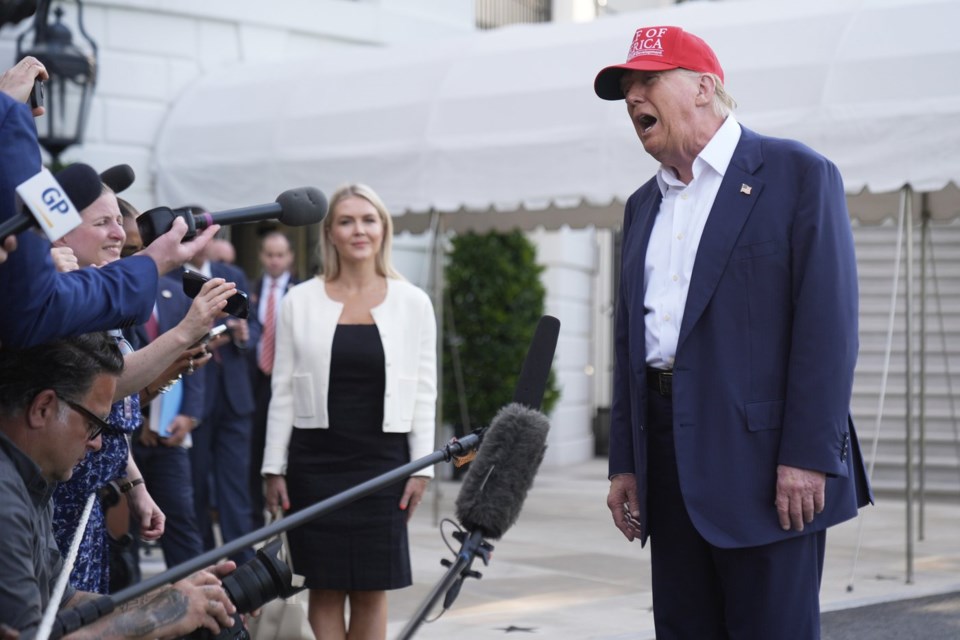 President Donald Trump speaks to the media before walking across the South Lawn of the White House to board Marine One en route to Joint Base Andrews, Md., and on to Florida, Tuesday, July 1, 2025, in Washington. (AP Photo/Mark Schiefelbein)