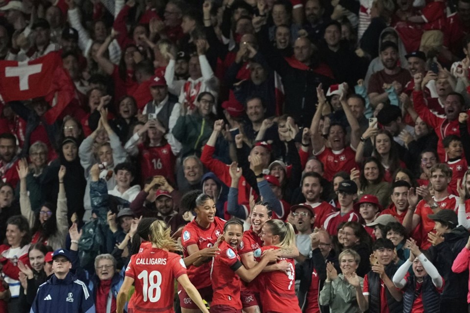 Switzerland's Geraldine Reuteler celebrates with team mates after scoring the opening goal during the Euro 2025, group A, soccer match between Switzerland and Iceland at Stadion Wankdorf in Bern, Switzerland, Sunday, July 6, 2025. (AP Photo/Martin Meissner)