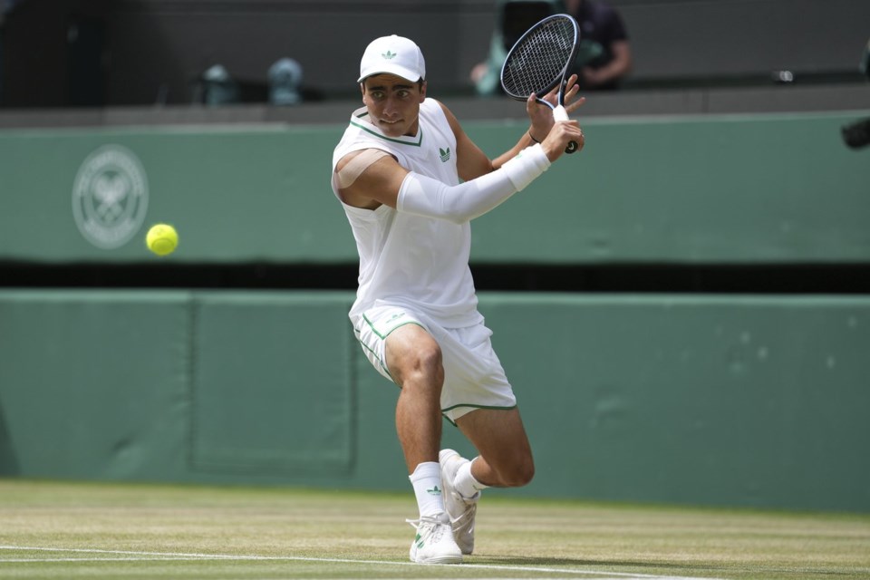 Ivan Ivanov of Bulgaria returns to Ronit Karki of the U.S. in the boys' singles final at the Wimbledon Tennis Championships in London, Sunday, July 13, 2025. (AP Photo/Dave Shopland)