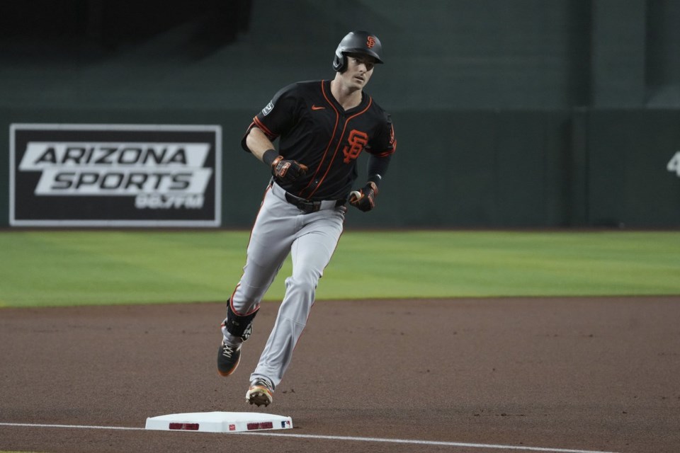 San Francisco Giants' Mike Yastrzemski circles the bases after hitting a solo home run against the Arizona Diamondbacks in the first inning during a baseball game, Wednesday, July 2, 2025, in Phoenix. (AP Photo/Rick Scuteri)