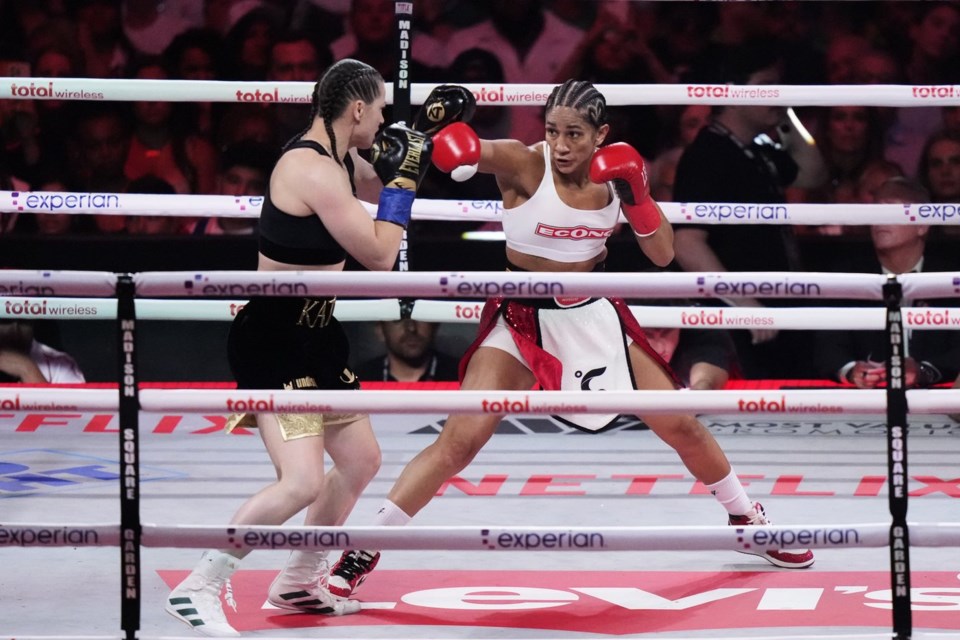 Puerto Rico's Amanda Serrano, right, punches Ireland's Katie Taylor during the second round of a super lightweight championship boxing match Friday, July 11, 2025, in New York. (AP Photo/Frank Franklin II)