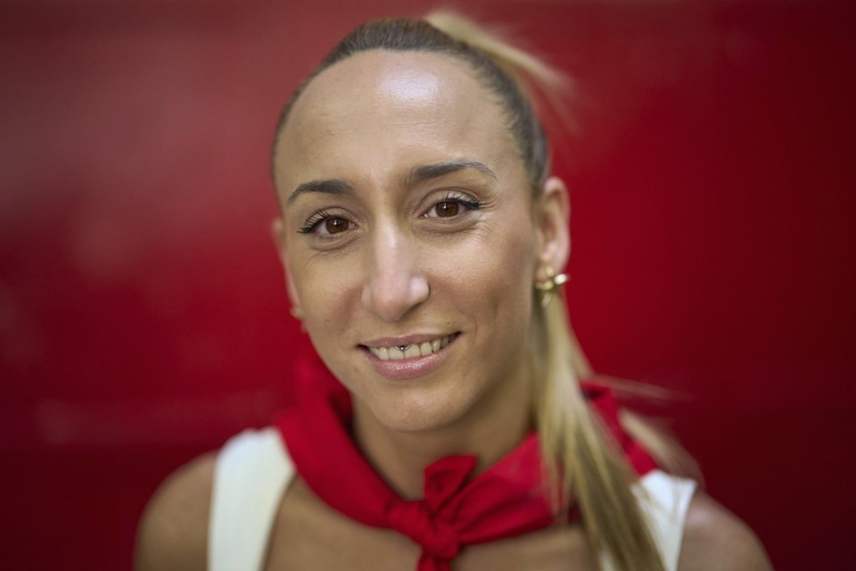 Bull-runner Paula Lopez poses for a portrait during the San Fermín festival in Pamplona, northern Spain, on Friday, July 11, 2025. (AP Photo/Miguel Oses)