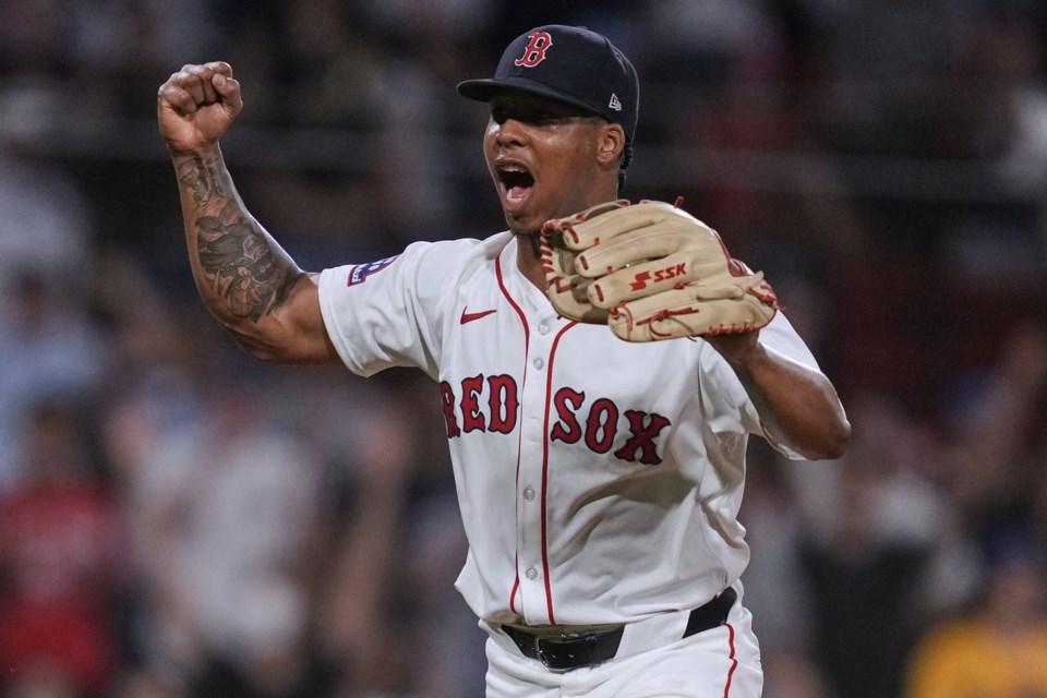 Boston Red Sox pitcher Brayan Bello celebrates after getting the win, throwing a complete game against the Colorado Rockies after a baseball game at Fenway Park, Tuesday, July 8, 2025, in Boston. (AP Photo/Charles Krupa)