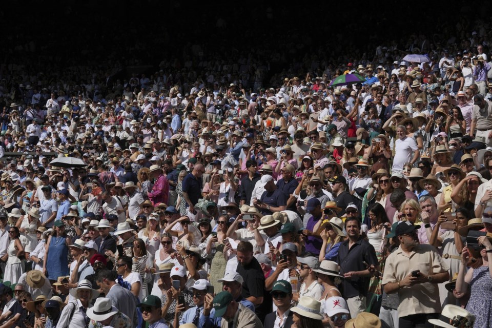 Crowds pack the stands of Centre Court before Italy's Jannik Sinner plays Carlos Alcaraz of Spain in the men's singles final at the Wimbledon Tennis Championships in London, Sunday, July 13, 2025. (AP Photo/Kin Cheung)