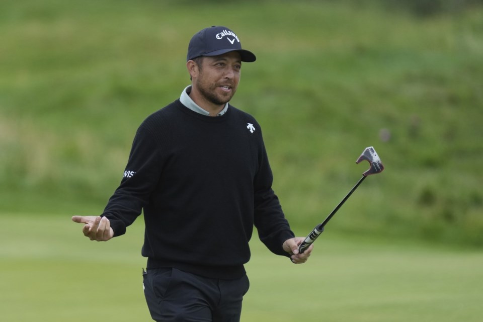 Xander Schauffele of the United States reacts after putting on the 13th green during a practice round for the British Open golf championship at the Royal Portrush Golf Club, Northern Ireland, Tuesday, July 15, 2025. (AP Photo/Jon Super)