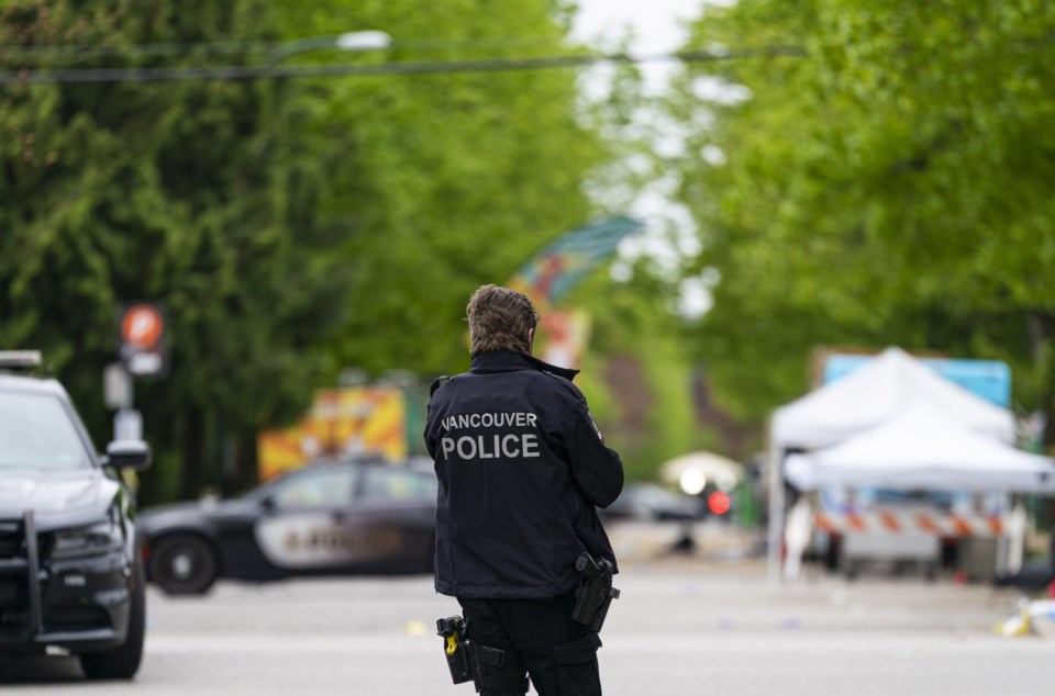 A Vancouver Police officer stands on a street leading to the site where a car drove through a crowd at a Lapu Lapu festival killing multiple people in Vancouver, Monday April 28, 2025. THE CANADIAN PRESS/Rich Lam