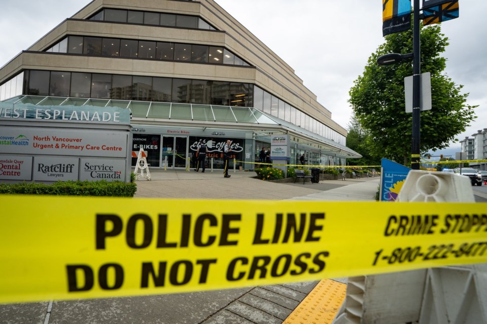RCMP officers wait outside of MLA Bowinn Ma's office after an explosion early in the morning in North Vancouver, B.C. on Friday, June 27, 2025. THE CANADIAN PRESS/Ethan Cairns
