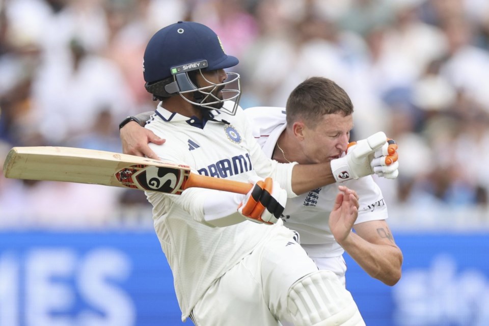 England's Brydon Carse, right, and India's Ravindra Jadeja collided during the fifth day of the third cricket test match between England and India at Lord's cricket ground in London, Monday, July 14, 2025. (AP Photo/Richard Pelham)