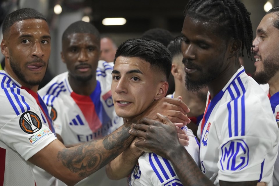 FILE - Lyon's Thiago Almada, centre, celebrates with teammates after scoring the opening goal during the Europa League quarterfinal first leg soccer match between Lyon and Manchester United at Groupama stadium in Decines, outside Lyon, France, April 10, 2025. (AP Photo/Thibault Camus, File)