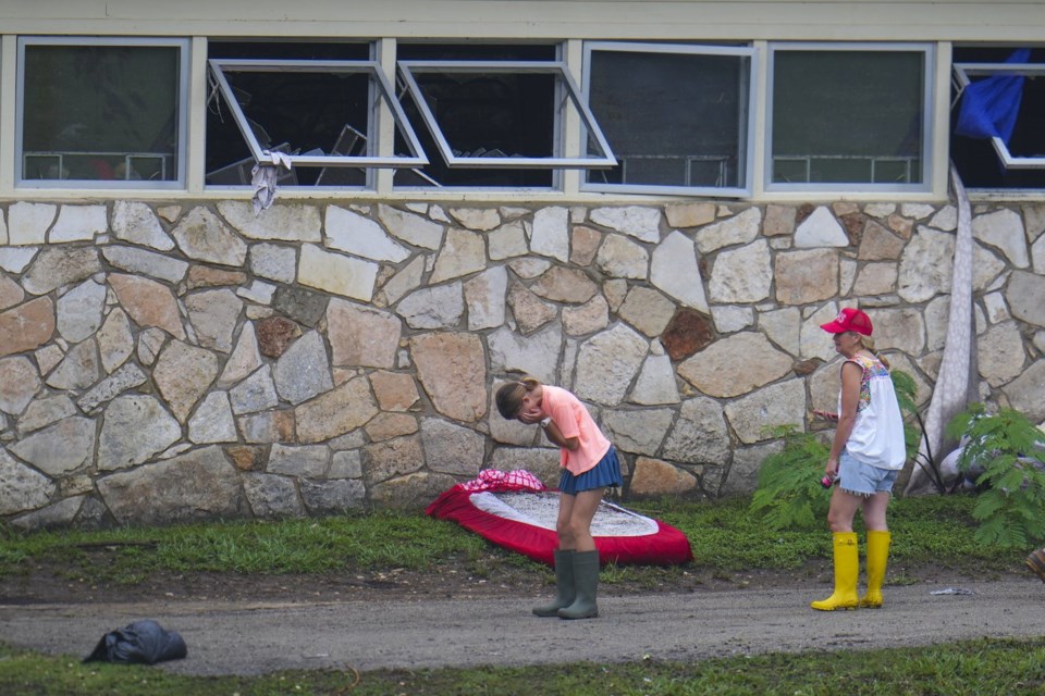People react as they inspect an area outside sleeping quarters at Camp Mystic along the banks of the Guadalupe River after a flash flood swept through the area Sunday, July 6, 2025, in Hunt, Texas. (AP Photo/Julio Cortez)