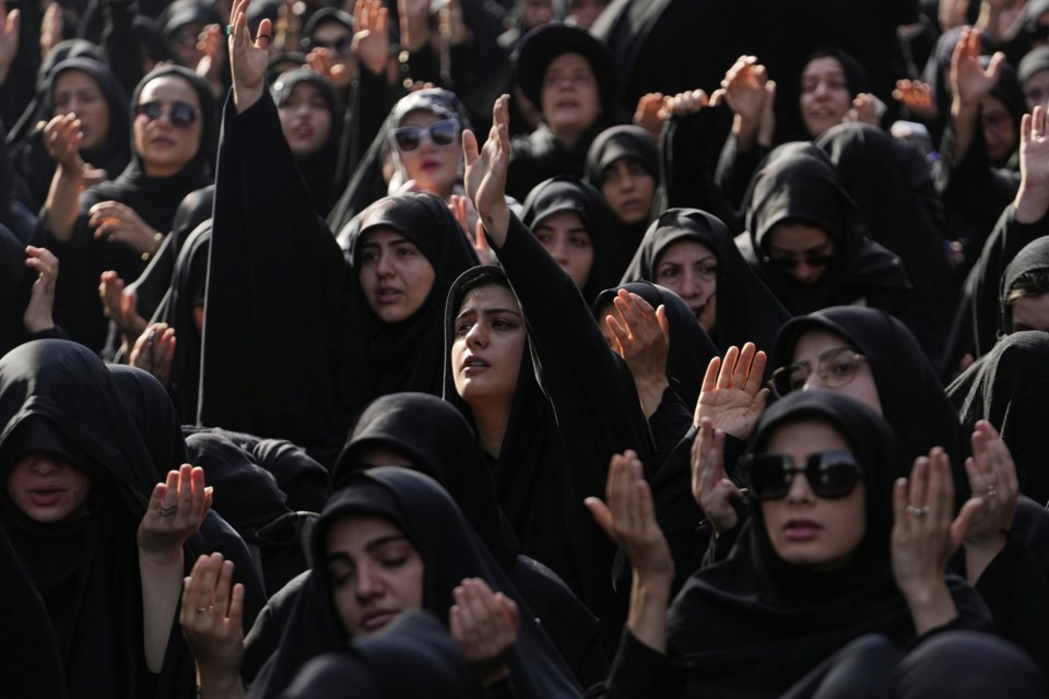 Iranian Shiite Muslims pray in a mourning ceremony in Tehran, Iran, Friday, July 4, 2025, ahead of Ashoura, a remembrance of the 7th-century martyrdom of the Prophet Muhammad's grandson, Hussein, who was killed in a battle in Karbala in present-day Iraq. (AP Photo/Vahid Salemi)