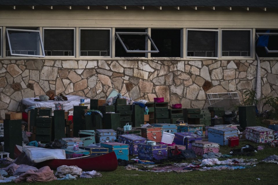 Camper's belongings sit outside one of Camp Mystic's cabins near the Guadalupe River after a flash flood swept through the area Monday, July 7, 2025, in Hunt, Texas. (AP Photo/Eli Hartman)