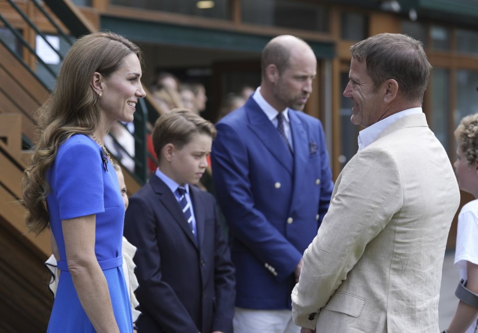 Britain's Prince William, second right, Kate, Princess of Wales, and Prince George meet Steve Backshall as they arrive to attend the men's singles final match between Italy's Jannik Sinner and Spain's Carlos Alcaraz at the Wimbledon Tennis Championships in London Sunday July 13, 2025. (Andrew Matthews/Pool via AP)