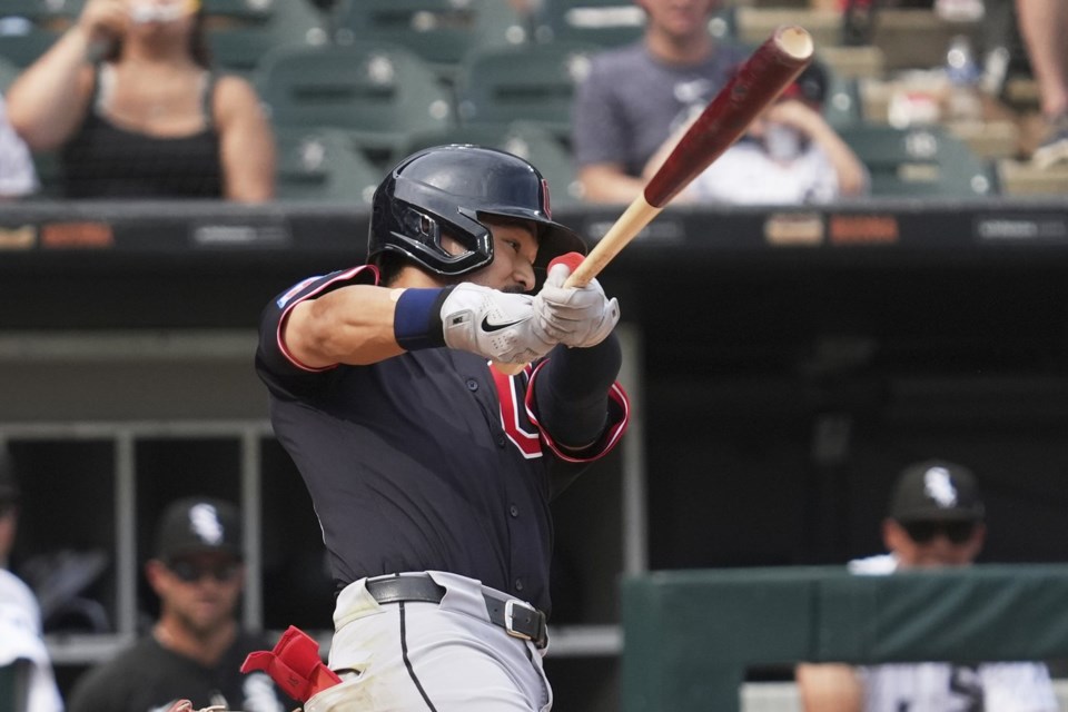 Cleveland Guardians' Steven Kwan hits a sacrifice fly during the 10th inning of a baseball game against the Chicago White Sox in Chicago, Sunday, July 13, 2025. (AP Photo/Nam Y. Huh)