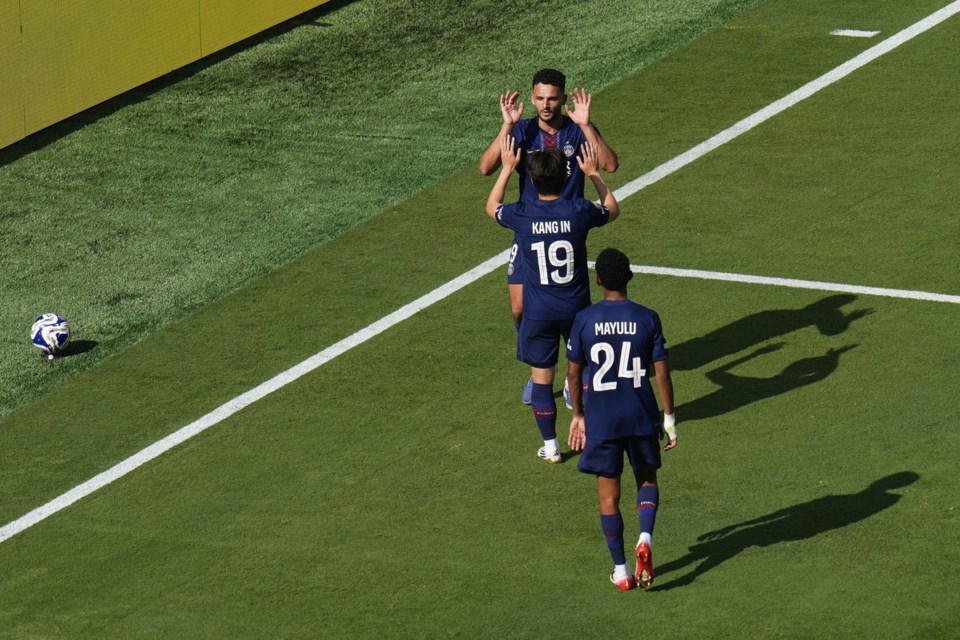 Paris Saint-Germain's Goncalo Ramos (9), rear, celebrates his goal with Lee Kang-in (19) and Senny Mayulu (24) during the Club World Cup semifinal soccer match between PSG and Real Madrid in East Rutherford, N.J., Wednesday, July 9, 2025. (AP Photo/Pamela Smith)