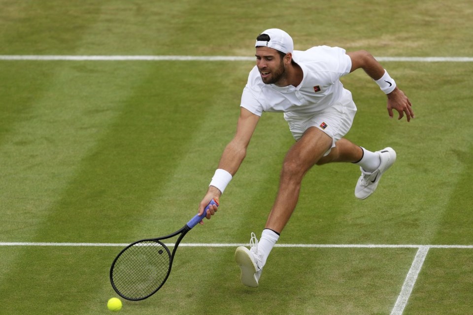 Karen Khachanov of Russia plays a return to Kamil Majchrzak of Poland during their men's singles fourth round match at the Wimbledon Tennis Championships in London, Sunday, July 6, 2025.(AP Photo/Kirsty Wigglesworth)